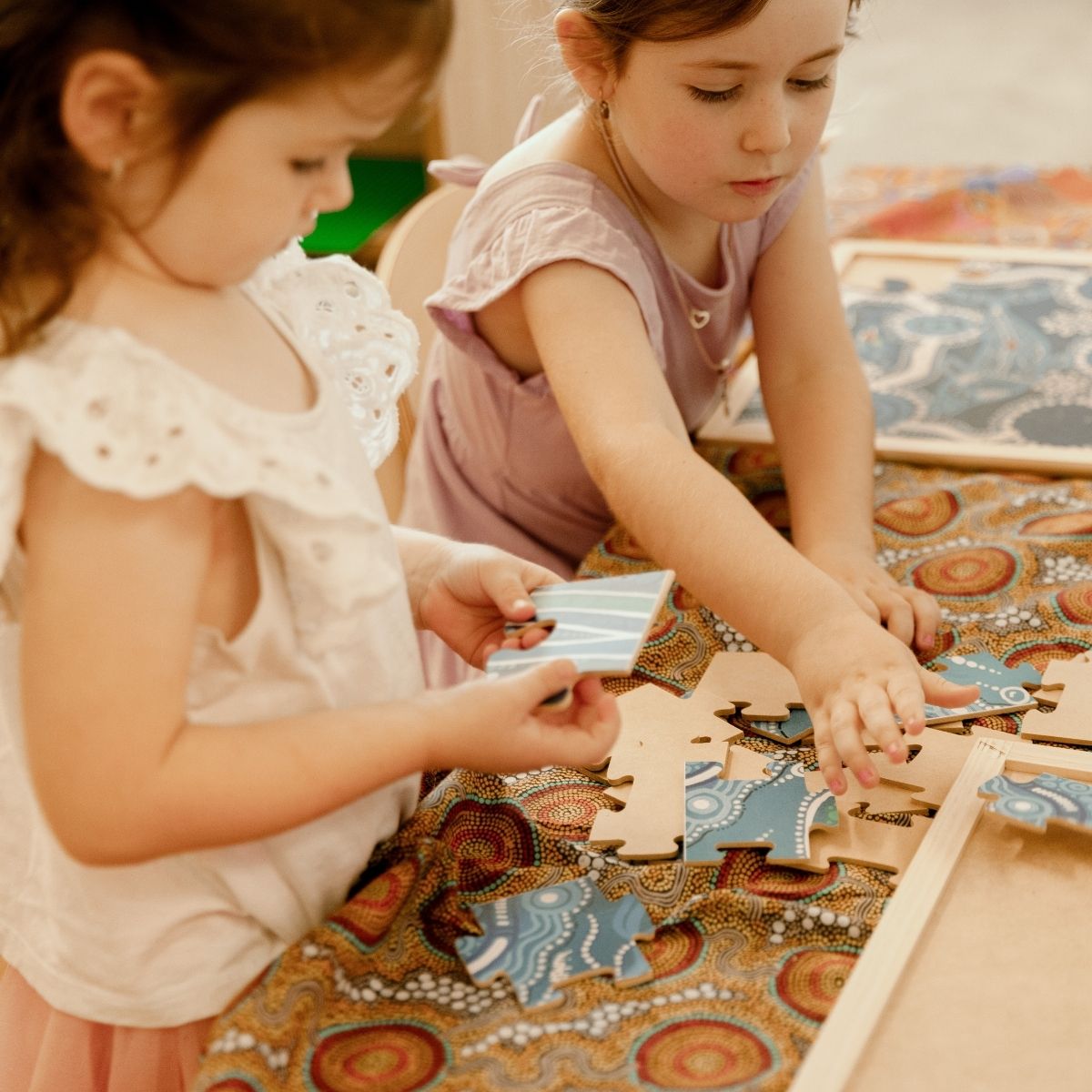 Two children playing with a puzzle